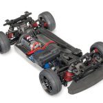 High-performance RC car chassis with shocks, motor, and tires for racing enthusiasts.
