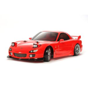 Red RC car replica of Mazda RX-7 with a sleek design and high performance.