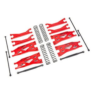 Red RC car chassis parts with springs and suspension components for off-road RC vehicles.