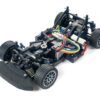 High-performance RC car chassis with brushless motor and off-road tires.