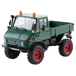 Detailed green RC truck with rugged tires for off-road racing.