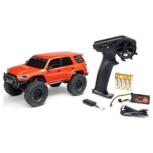 Remote control off-road RC car with accessories and batteries.