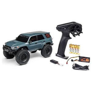Remote control car with large tires, rechargeable battery, transmitter, and accessories for RC car enthusiasts.
