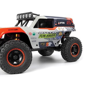 Bright orange and black RC monster truck with rugged off-road tires, ideal for RC car enthusiasts.