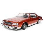 Vintage red classic car model with chrome details and realistic interior.